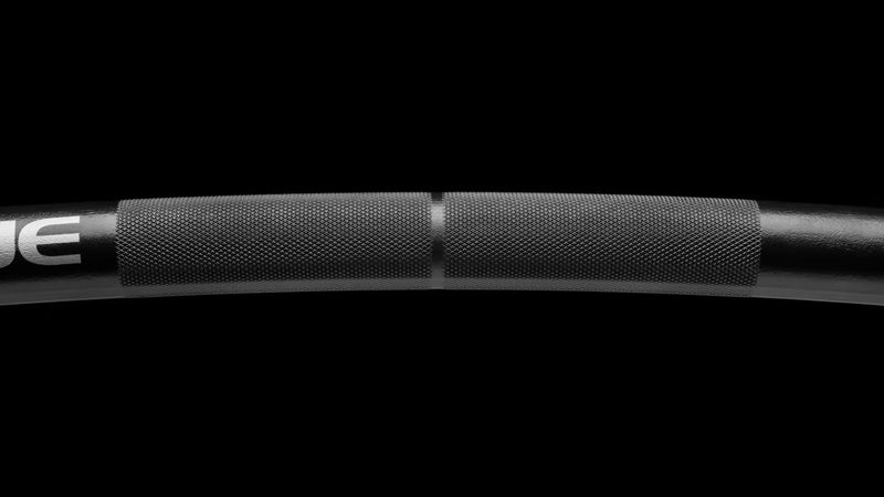 ROGUE CB-4 38mm キャンバーバー ブラック、シャフトの曲線部分とROGUEロゴを斜めから捉えたディテールビュー、キャンバー形状とローレット位置が分かるスペシャリティバーベル